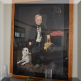 A35. Framed print of Victorian boy with small white dog. Frame: 32.5”h x 25.5”w 